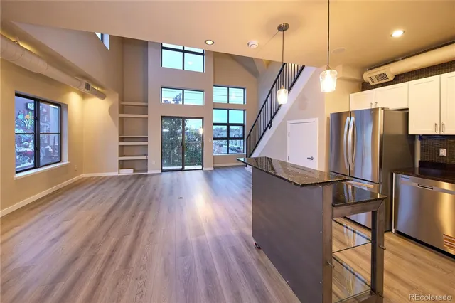 a view of kitchen with furniture and wooden floor
