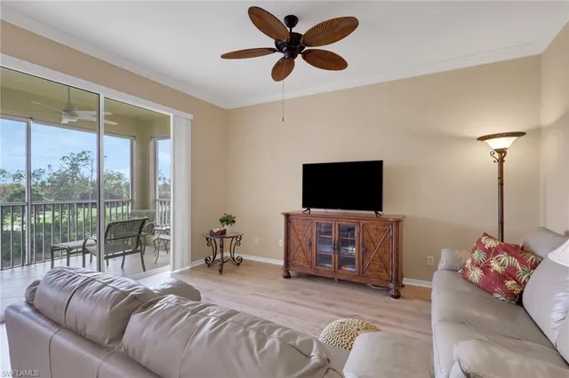 a bedroom with furniture and a flat screen tv
