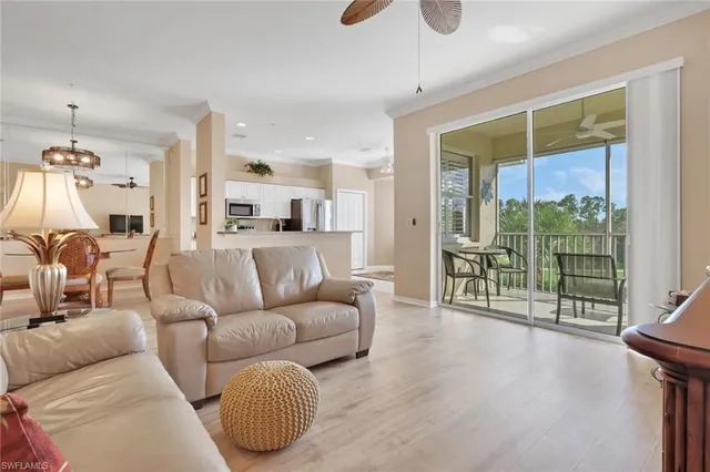 a living room with furniture and a floor to ceiling window