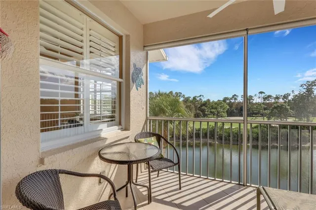 a front view of a house with a garden and lake