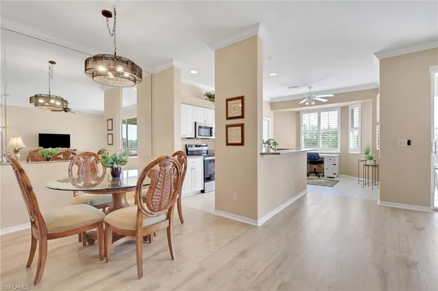 a dining room with furniture window and wooden floor