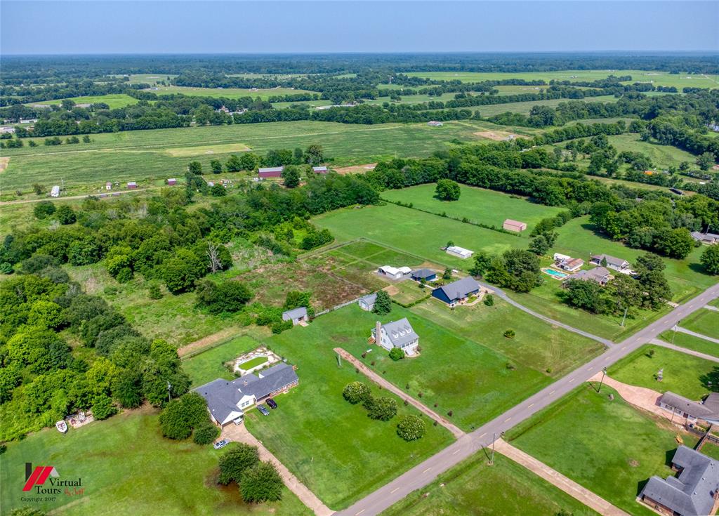 179 Ranchtown Road Elm Grove, LA 71051 - Photo 19 of 26 Expansive aerial overview showcasing multiple properties amidst agricultural fields and mature tree lines
