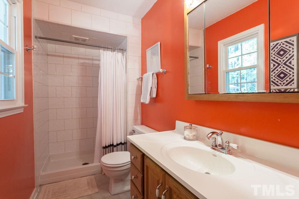1433 Clermont Road Durham, NC 27713 - Photo 22 of 29 a bathroom with a sink a toilet and shower