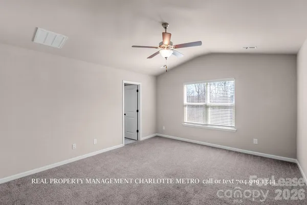 a view of a livingroom with a ceiling fan and wooden floor