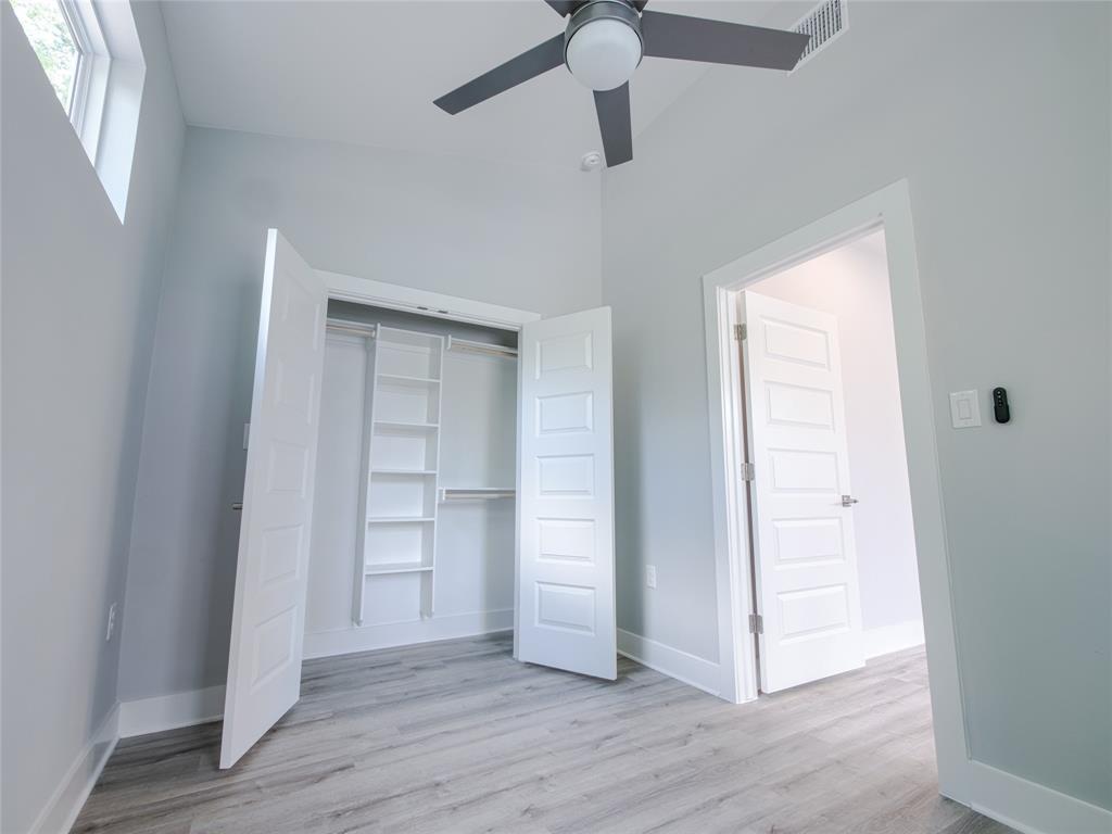 1042 Rosemont Street, Unit 2 Austin, TX 78723 - Photo 12 of 22 an empty room with wooden floor closet and windows