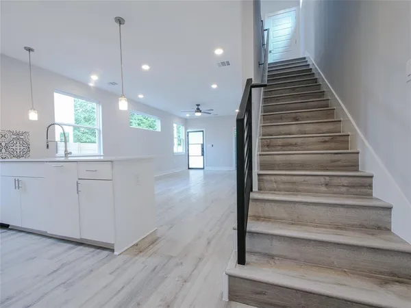a view of entryway and hall with wooden floor