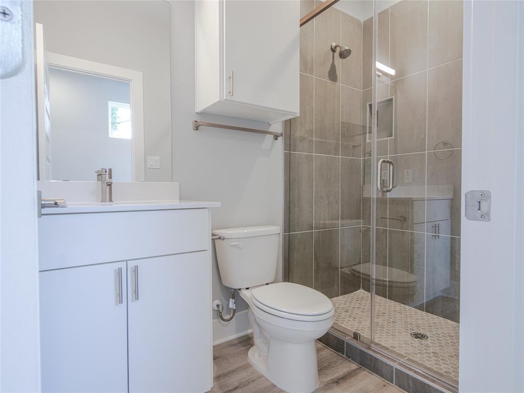 1042 Rosemont Street, Unit 2 Austin, TX 78723 - Photo 16 of 22 a bathroom with a shower a toilet and sink