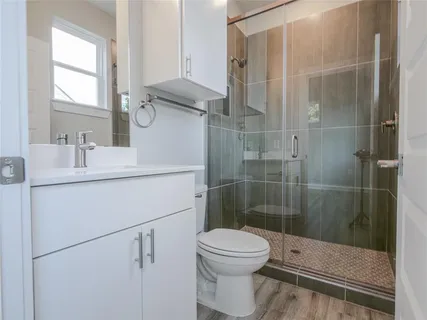 a bathroom with a sink toilet and shower
