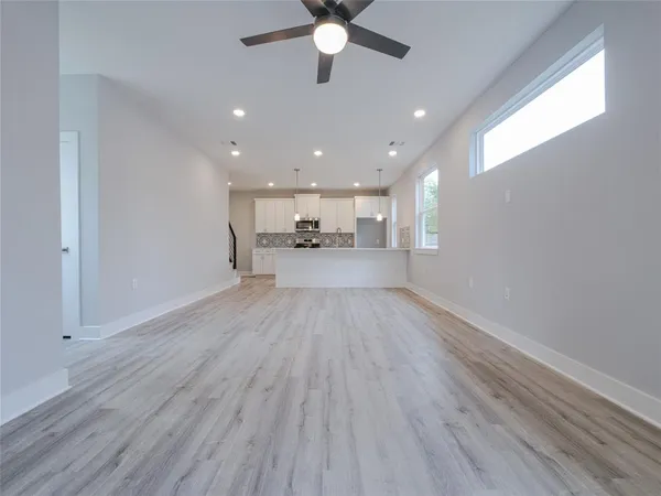 a view of a kitchen with a sink and wooden floor