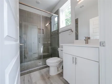 a bathroom with a sink toilet and shower