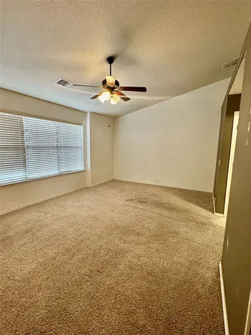 a view of an empty room and a window