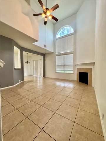 a view of an empty room with a fireplace and a window