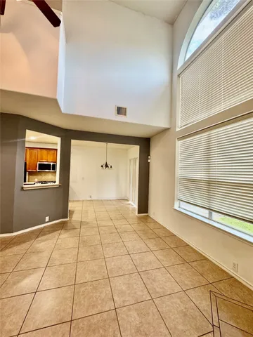a view of a hallway with a ceiling fan