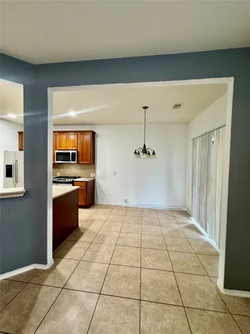 a kitchen with sink and refrigerator