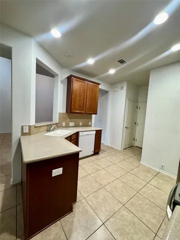 a kitchen with stainless steel appliances granite countertop a sink and a stove top oven