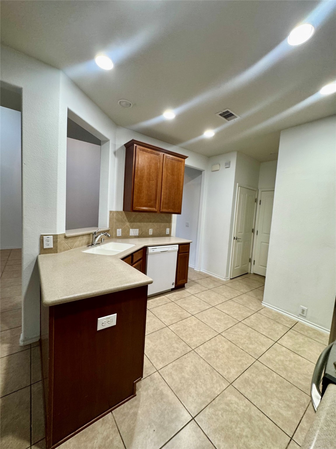 13600 Breton Ridge Street, Unit 36C Houston, TX 77070 - Photo 26 of 40 a kitchen with sink and refrigerator