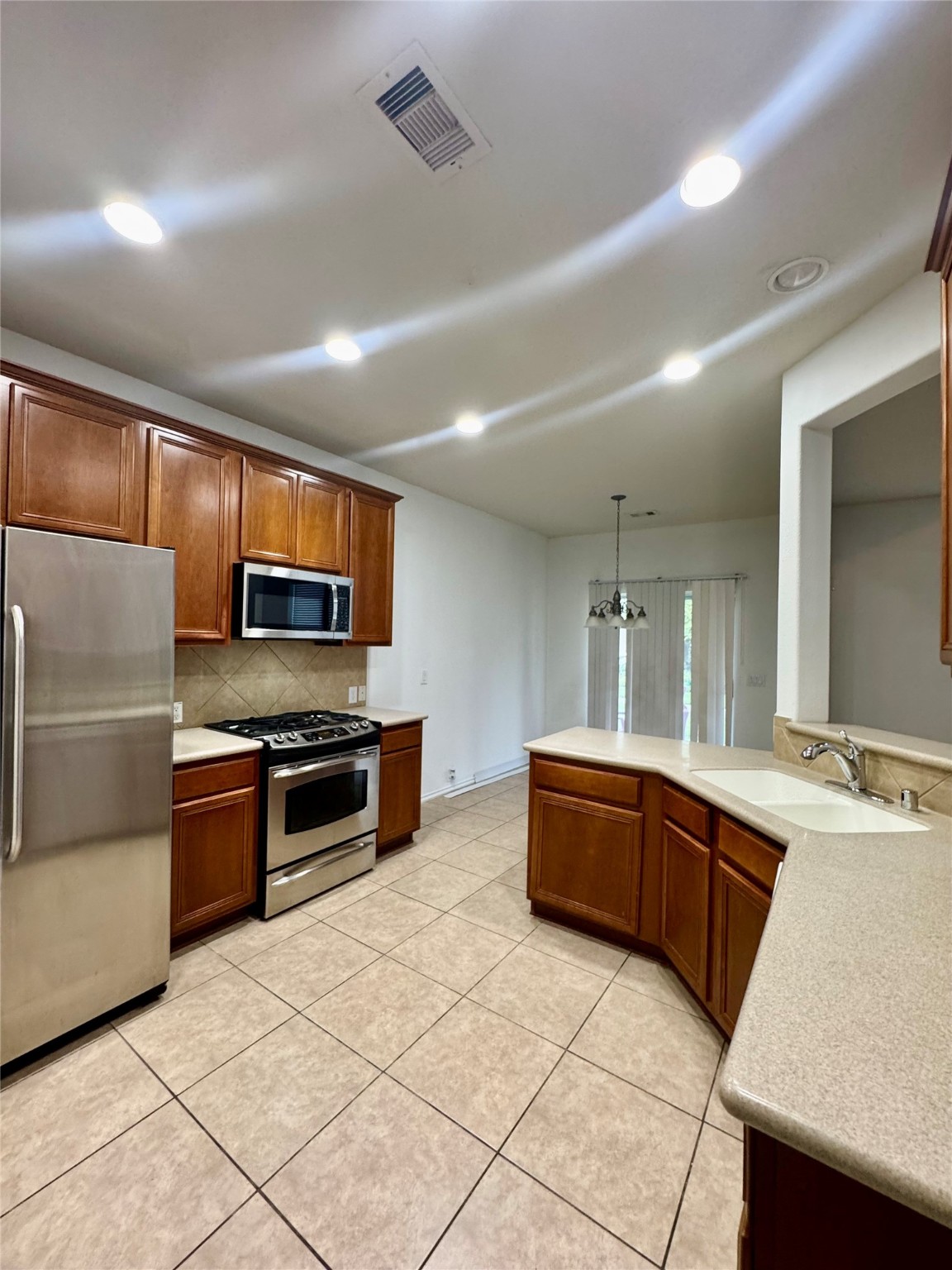 13600 Breton Ridge Street, Unit 36C Houston, TX 77070 - Photo 29 of 40 a kitchen with stainless steel appliances granite countertop a sink dishwasher stove top oven and refrigerator