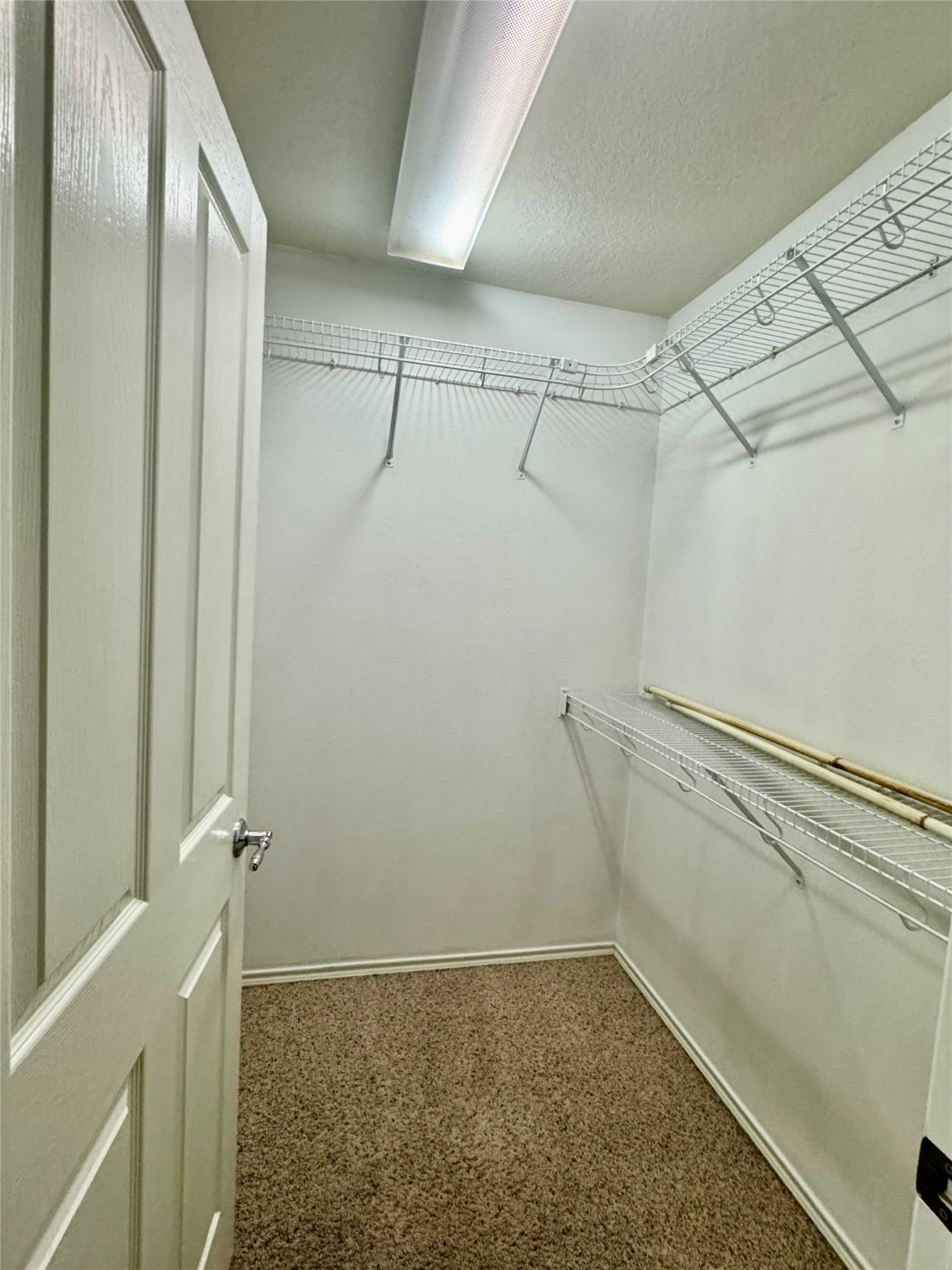 13600 Breton Ridge Street, Unit 36C Houston, TX 77070 - Photo 10 of 40 a view of a room with racks on the wall