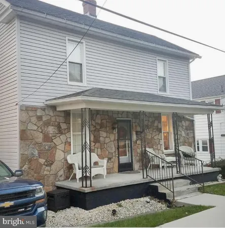 a view of a patio with table and chairs and potted plants