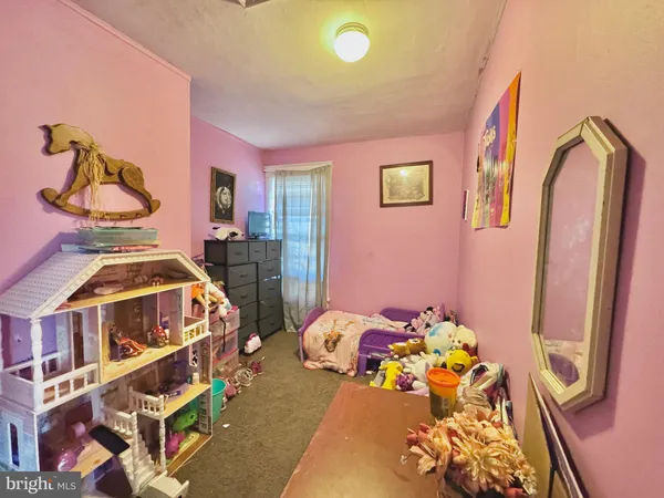 a bedroom with a bed dresser and a window