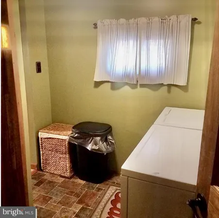 a view of a small house with a yard