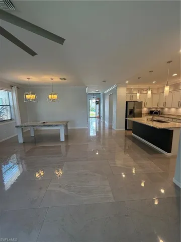 a view of kitchen with kitchen island and stainless steel appliances