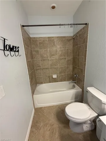 a bathroom with a toilet and a bathtub
