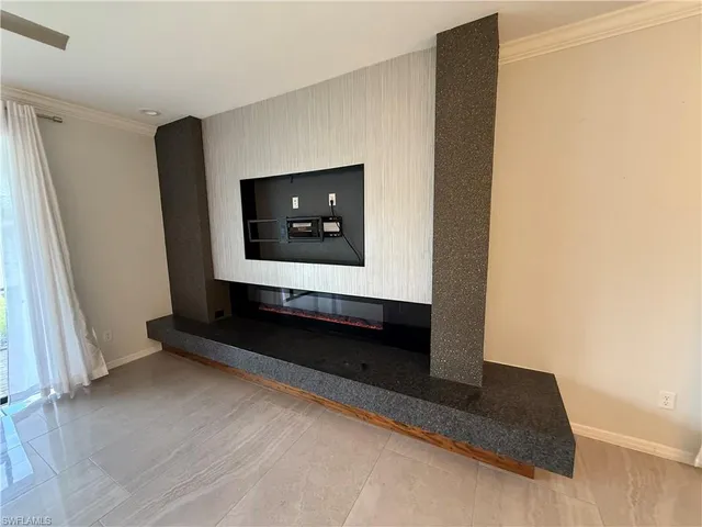 a living room with a rug and a flat screen tv