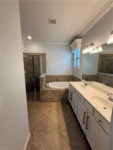 a large bathroom with a large tub and double vanity