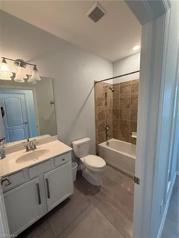 a bathroom with a double vanity sink toilet mirror and shower