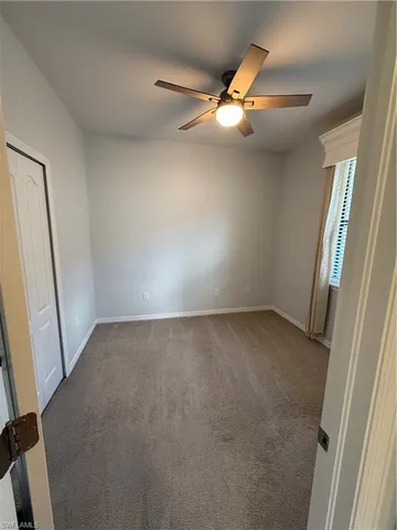 an empty room with a ceiling fan and hardwood floor