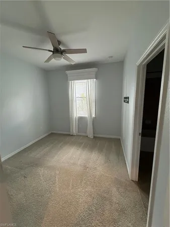 an empty room with windows and entrance