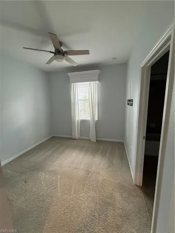 an empty room with windows and entrance