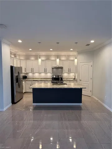 a large bathroom with a large tub and large stainless steel appliances
