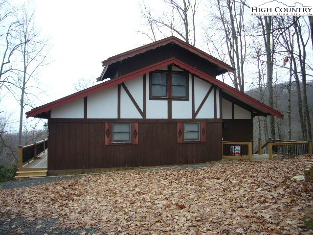 726 Pine Ridge Road Beech Mountain, NC 28604 - Photo 1 of 19 a front view of a house with a yard
