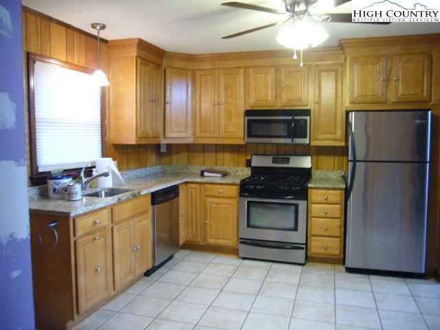 726 Pine Ridge Road Beech Mountain, NC 28604 - Photo 6 of 19 a kitchen with a refrigerator and a sink