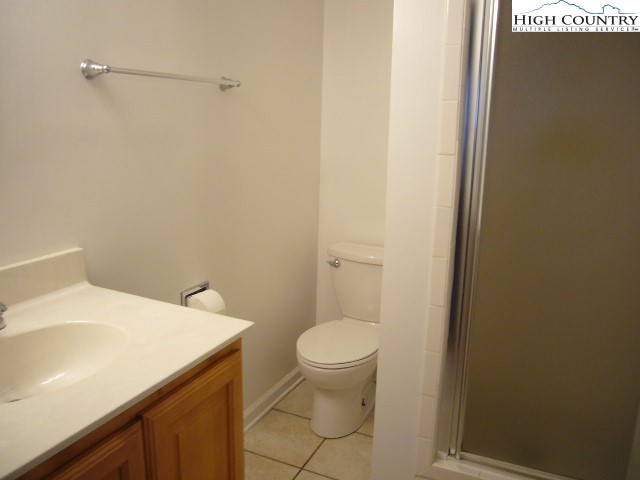 726 Pine Ridge Road Beech Mountain, NC 28604 - Photo 9 of 19 a bathroom with a sink a toilet and a mirror