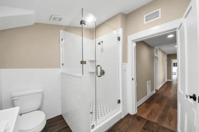 a bathroom with a shower toilet and sink