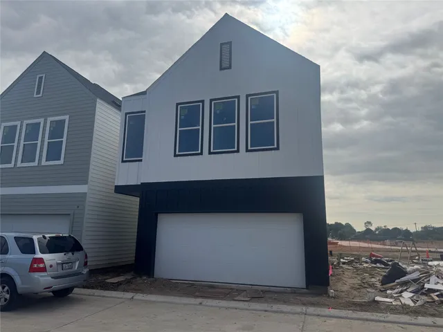 a front view of a house with a road