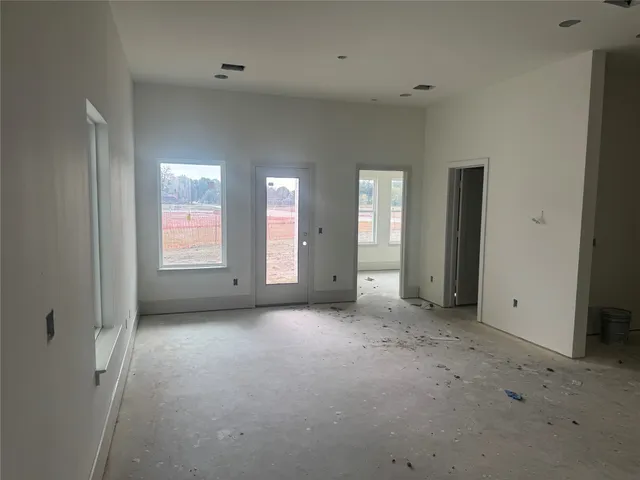 an empty room with windows and closet
