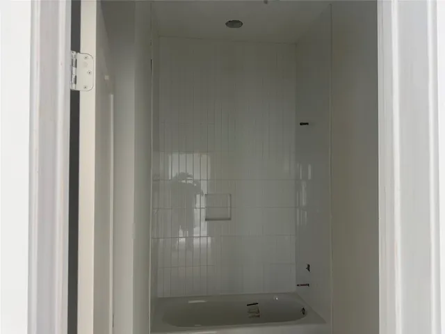 a bathroom with a glass shower door
