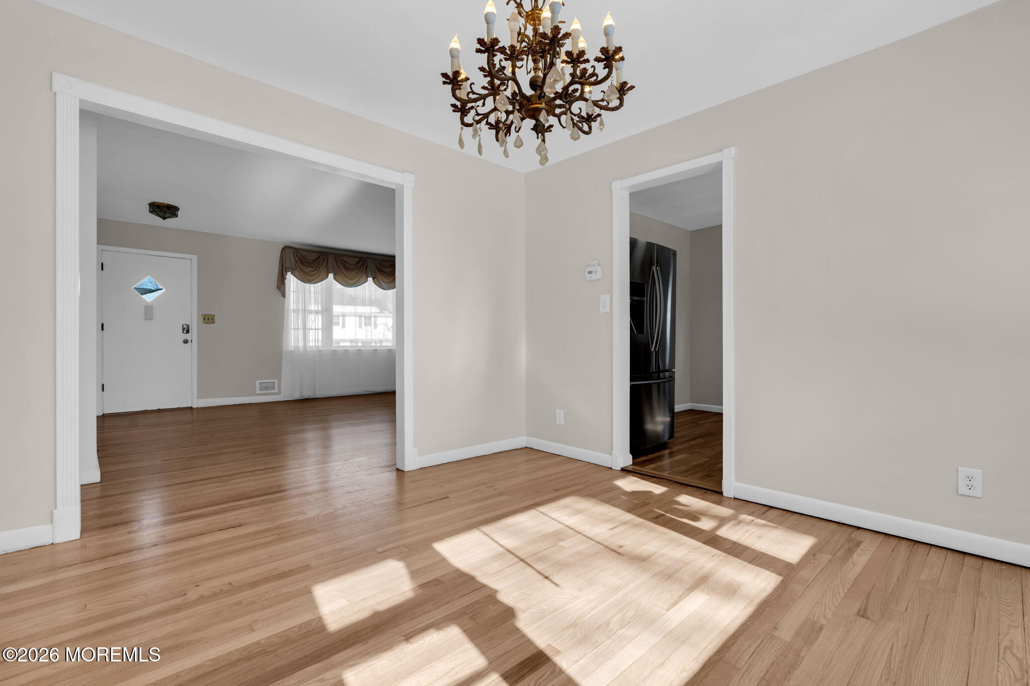 7 Klein Street Oakhurst, NJ 07755 - Photo 11 of 25 an empty room with wooden floor and chandelier