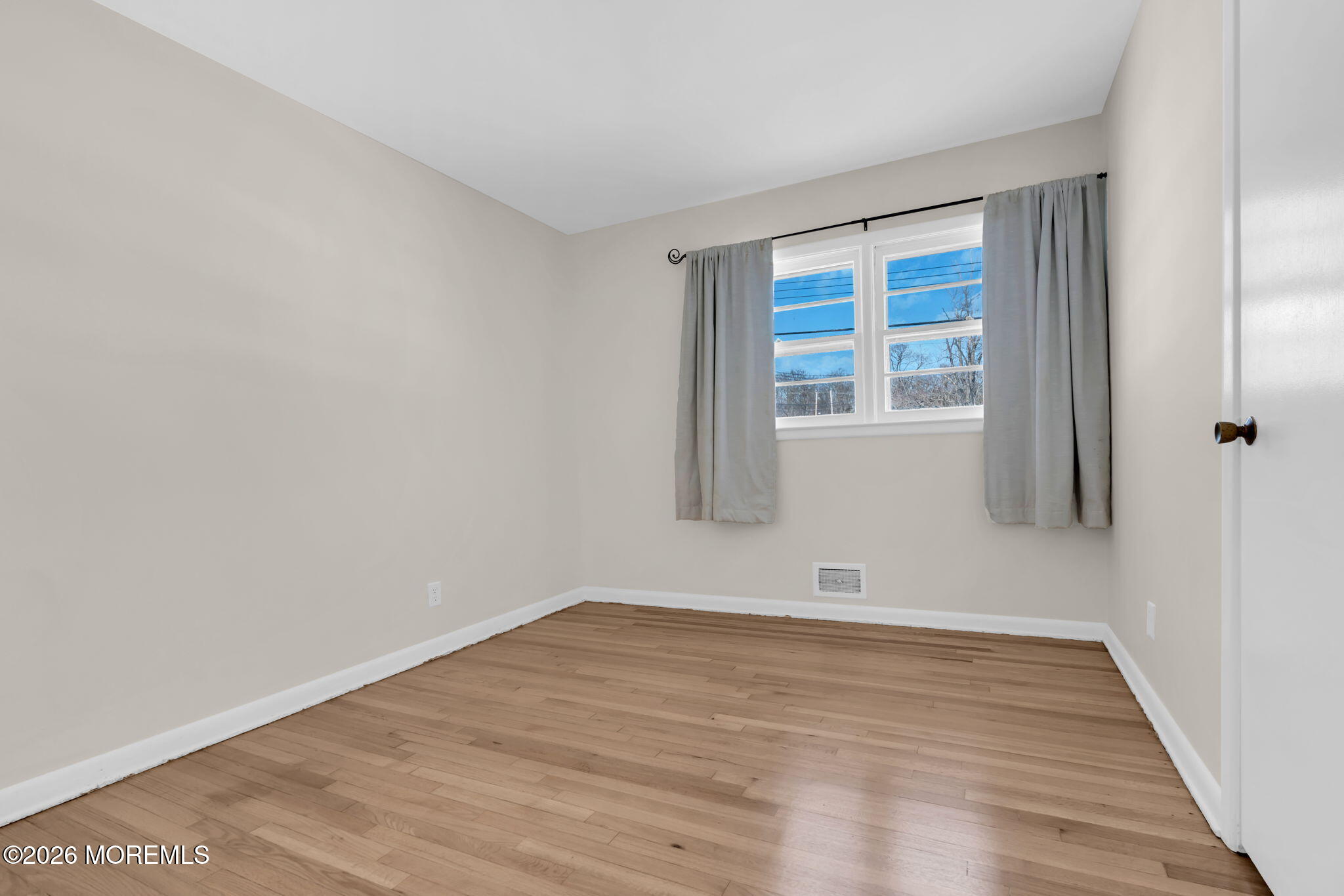 7 Klein Street Oakhurst, NJ 07755 - Photo 13 of 25 a view of an empty room with wooden floor and a window