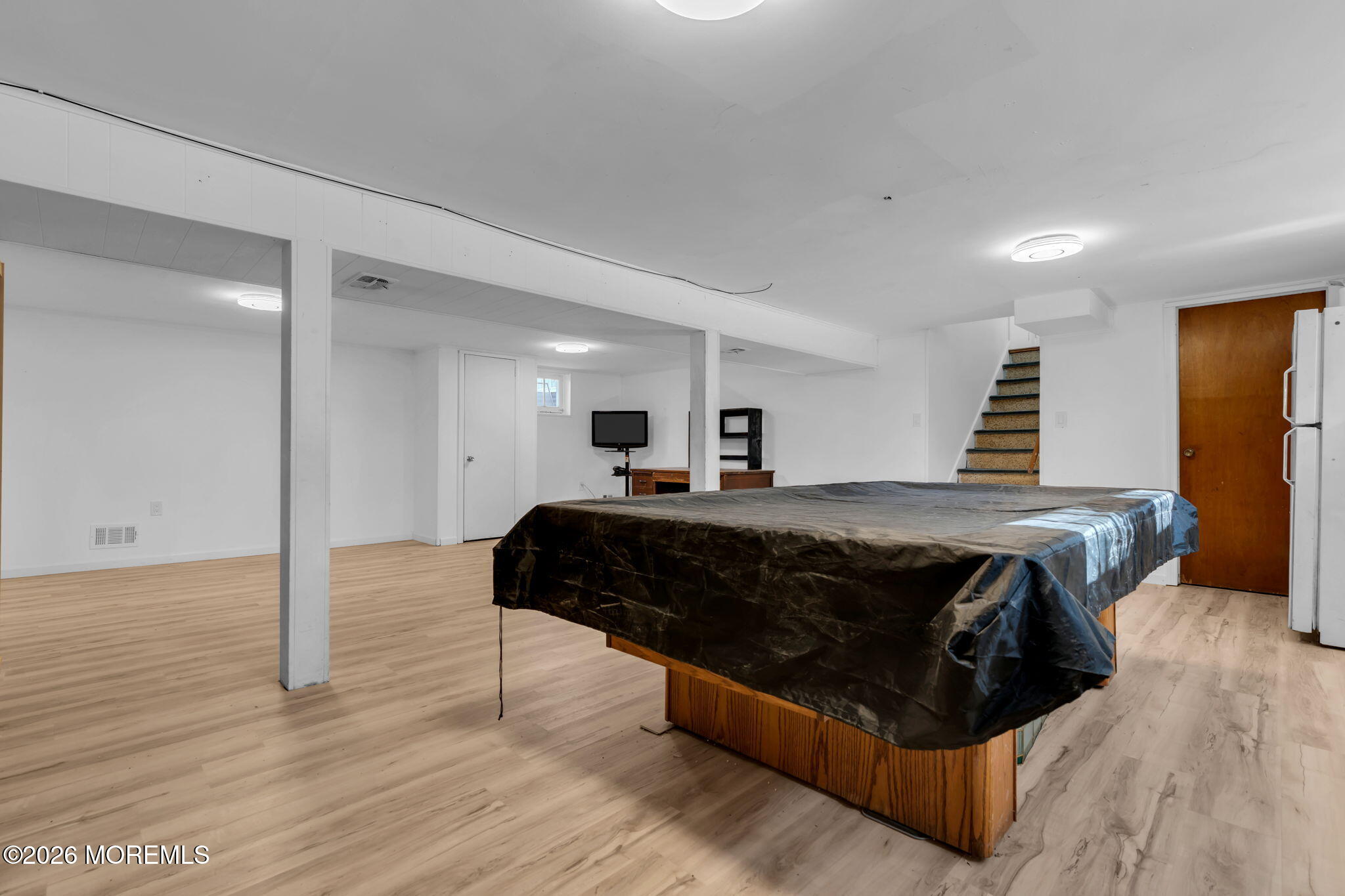 7 Klein Street Oakhurst, NJ 07755 - Photo 21 of 25 a bedroom with a bed and wooden floor