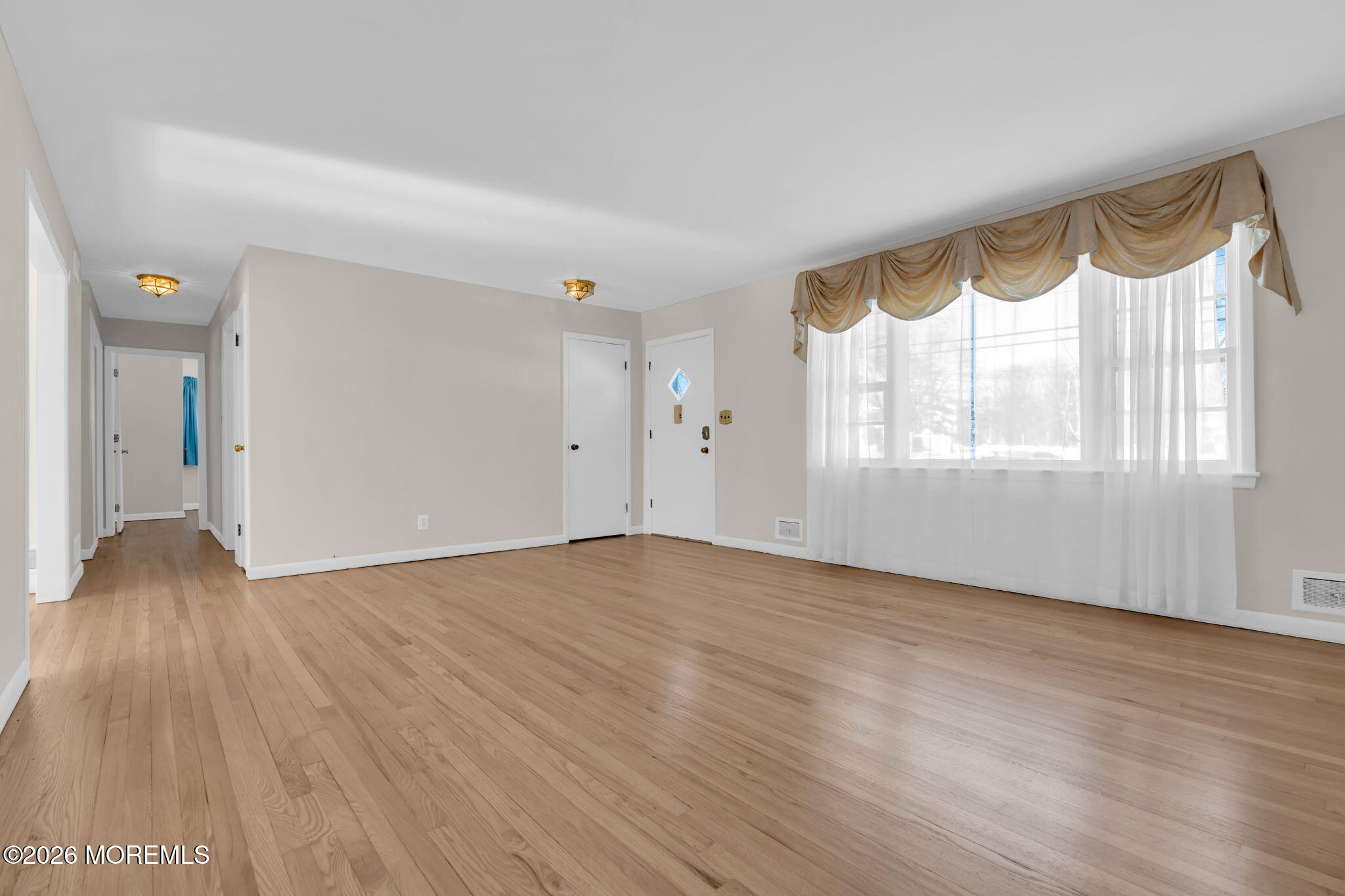 7 Klein Street Oakhurst, NJ 07755 - Photo 3 of 25 a view of an empty room with wooden floor and a window