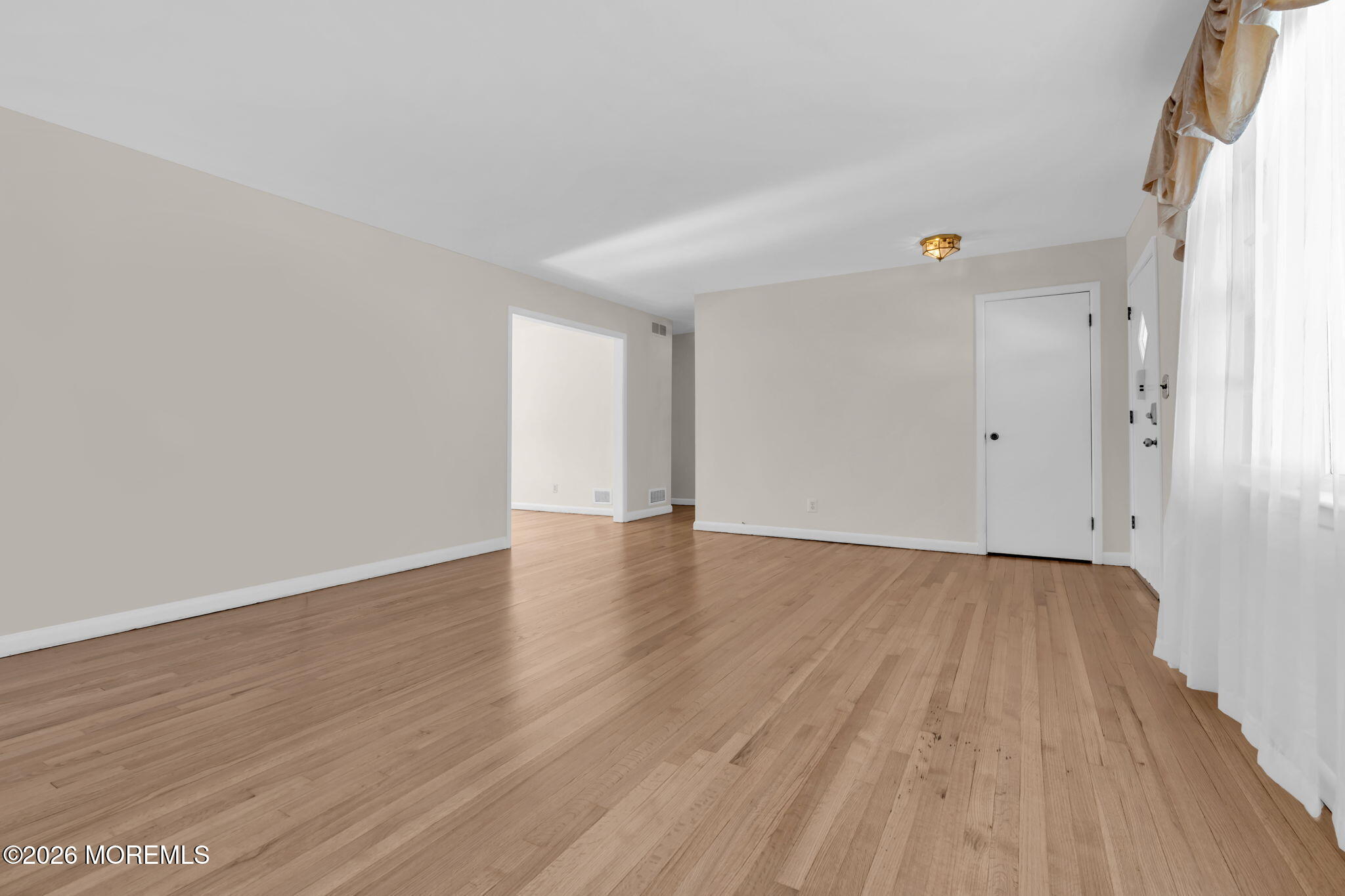 7 Klein Street Oakhurst, NJ 07755 - Photo 4 of 25 a view of an empty room with wooden floor and a window