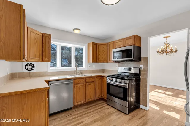 a kitchen with stainless steel appliances a stove sink and microwave