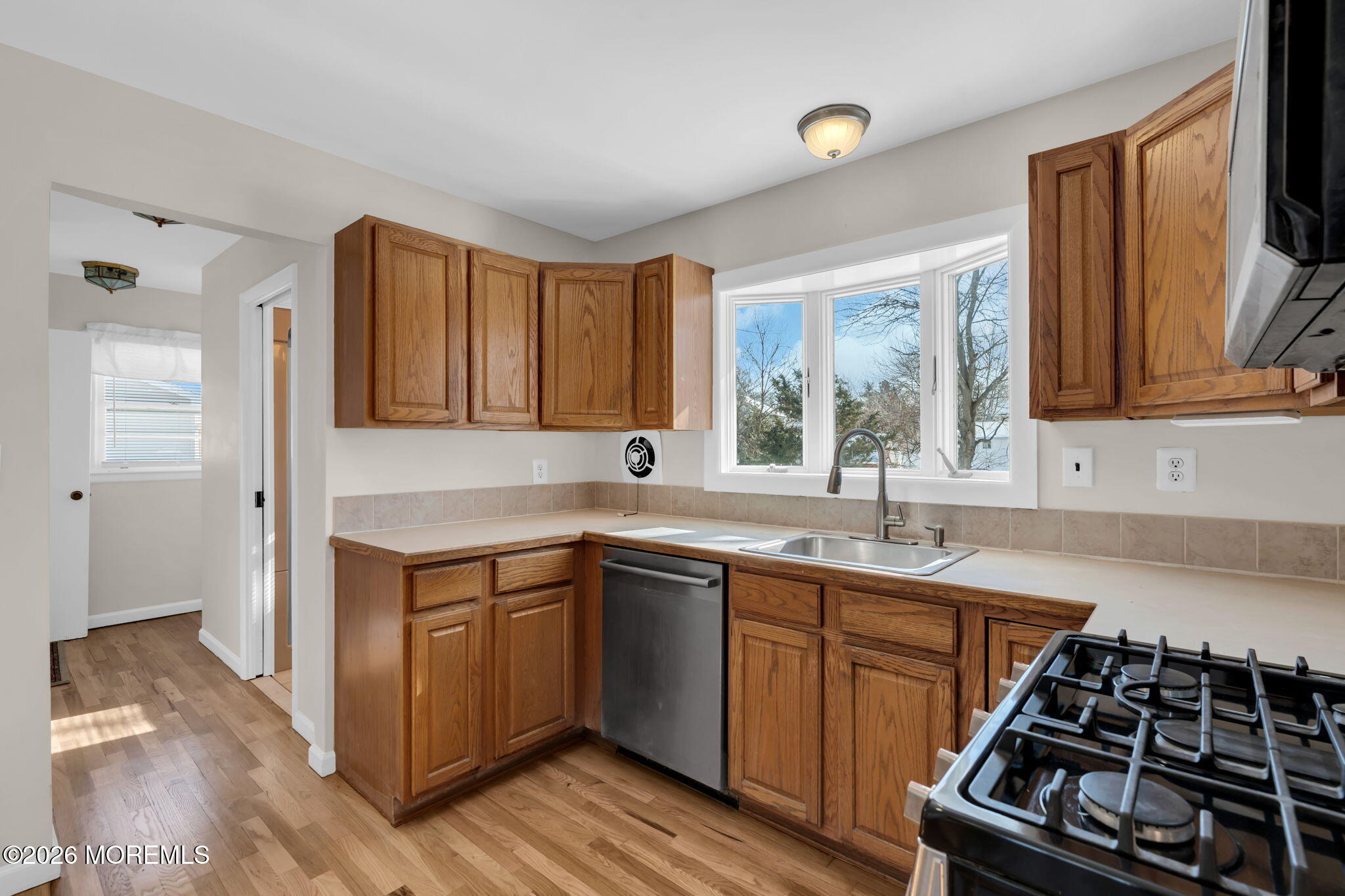 7 Klein Street Oakhurst, NJ 07755 - Photo 7 of 25 a kitchen with a sink stove and cabinets