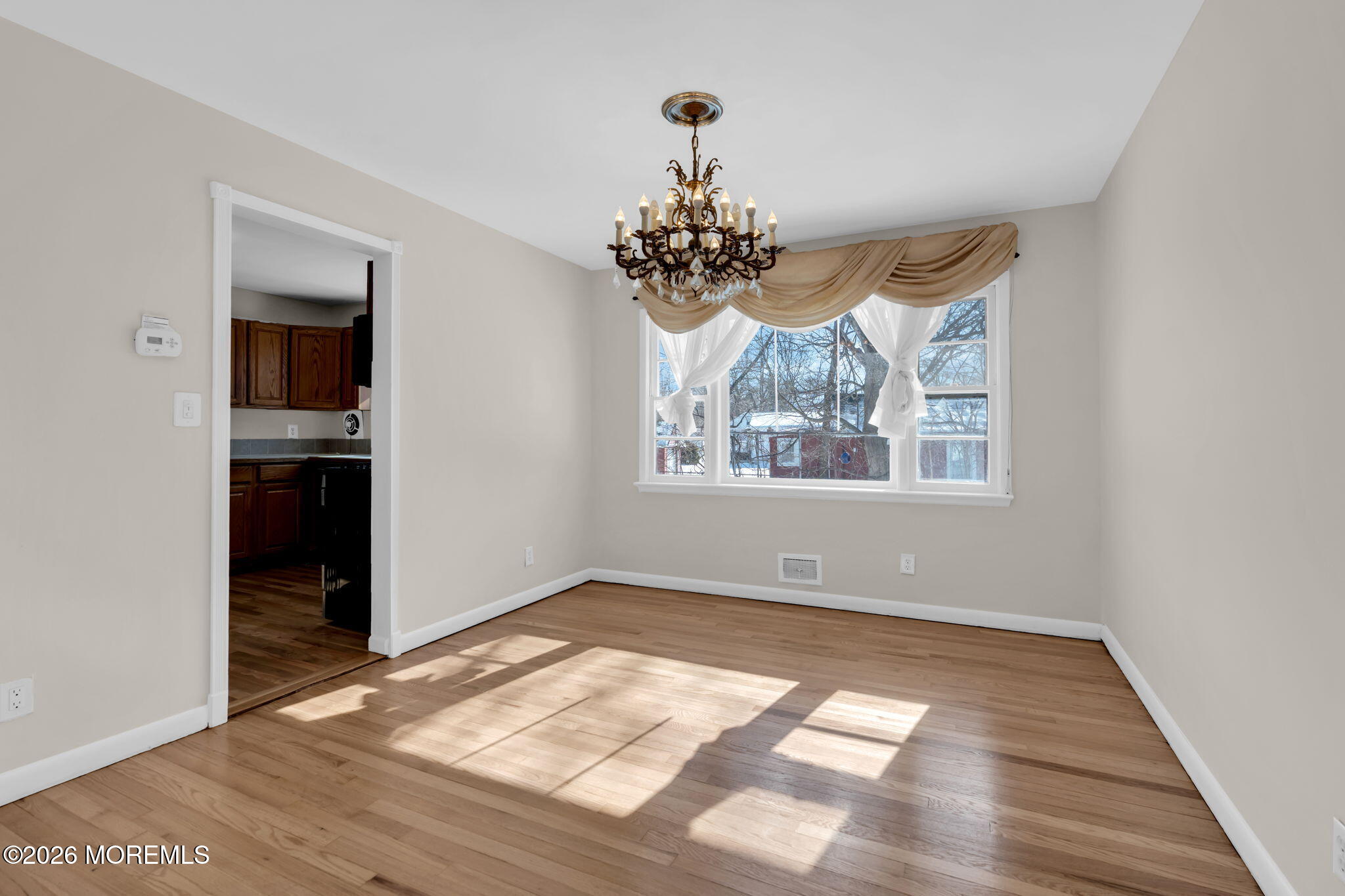 7 Klein Street Oakhurst, NJ 07755 - Photo 10 of 25 wooden floor in an empty room with a window