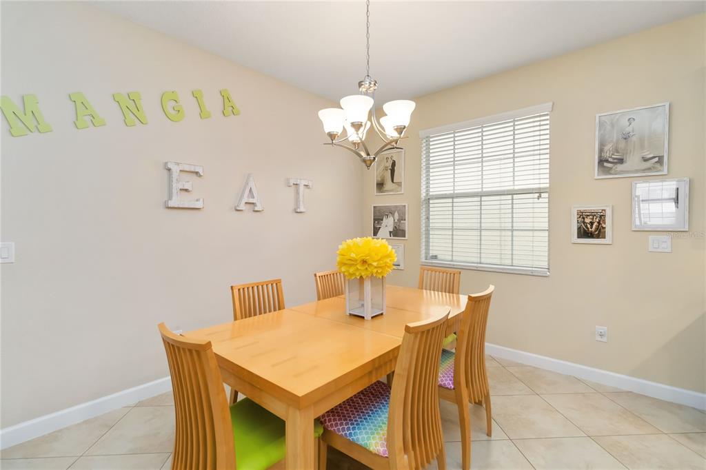 6805 Sundrop Street Harmony, FL 34773 - Photo 11 of 24 a view of a dining room with furniture and chandelier